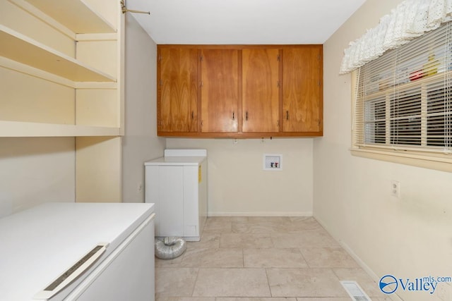 washroom with cabinets and light tile patterned floors