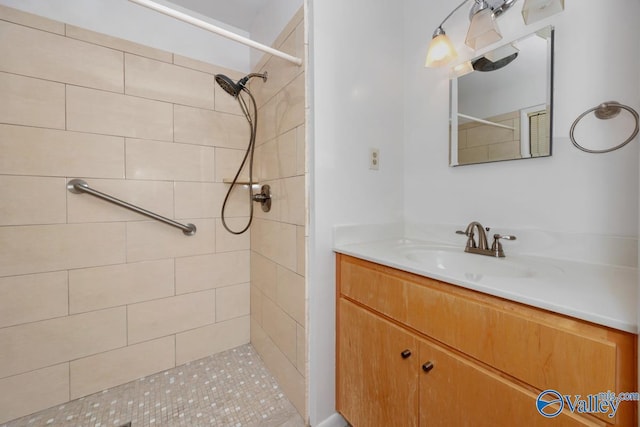 bathroom with vanity and a tile shower