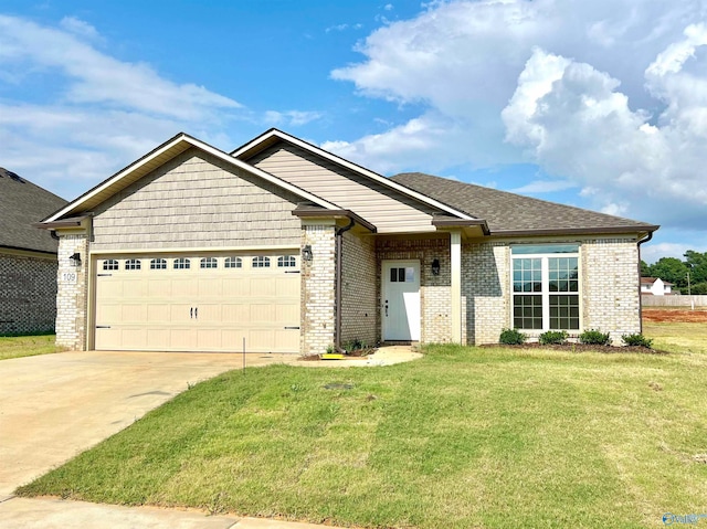 view of front of home featuring a front yard and a garage