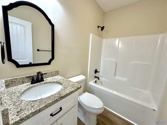 full bathroom with toilet, vanity, shower / bathing tub combination, and wood-type flooring