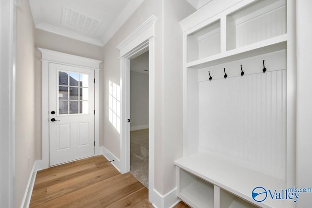 mudroom featuring hardwood / wood-style flooring and ornamental molding