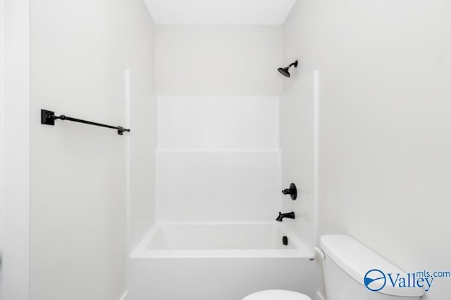 bathroom featuring shower / bathtub combination and toilet