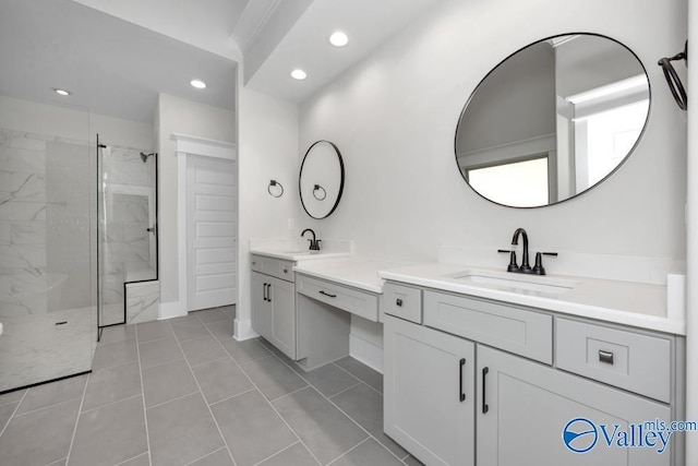 bathroom featuring tile patterned flooring, vanity, and walk in shower