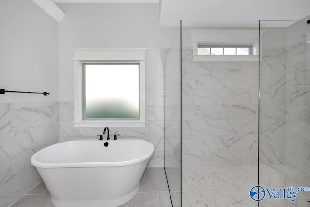 bathroom featuring tile walls and plus walk in shower