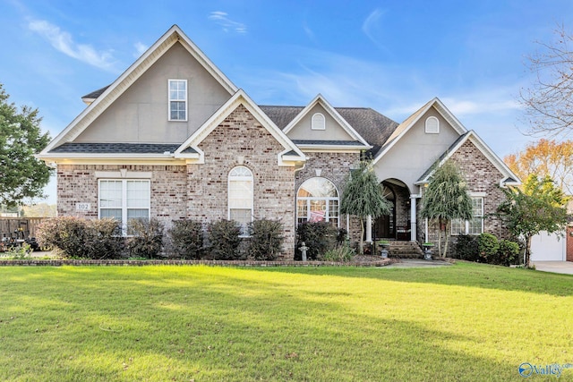 102 Casey Dr, Huntsville, AL 35806 - view of front of home with a front lawn, brick siding, a shingled roof, and stucco siding