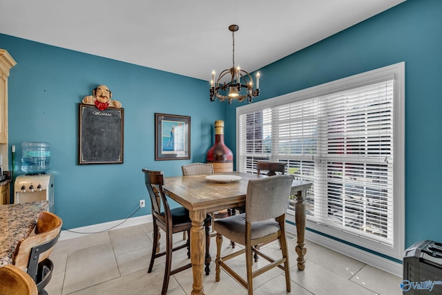 tiled dining room with a notable chandelier