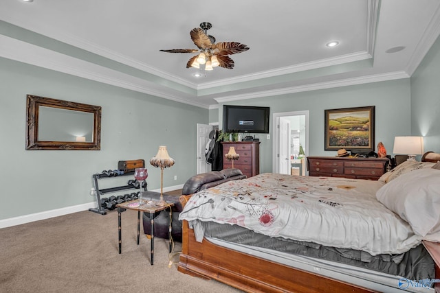 carpeted bedroom with a raised ceiling, ceiling fan, and crown molding