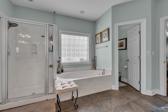 bathroom featuring tile patterned flooring, toilet, and independent shower and bath