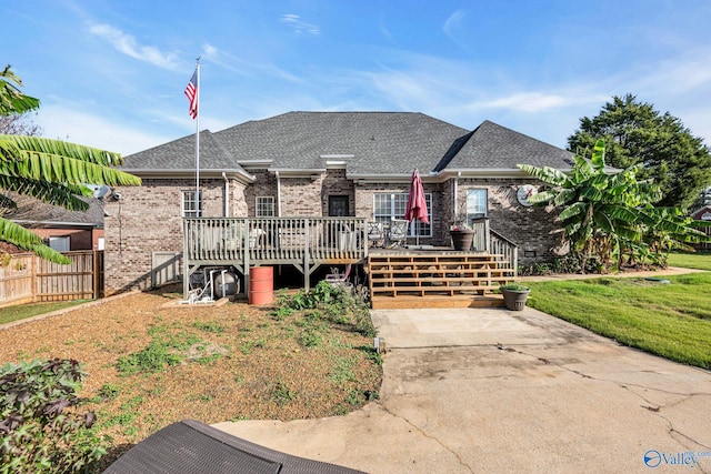 102 Casey Dr, Huntsville, AL 35806 - view of front facade with brick siding, a deck, and roof with shingles