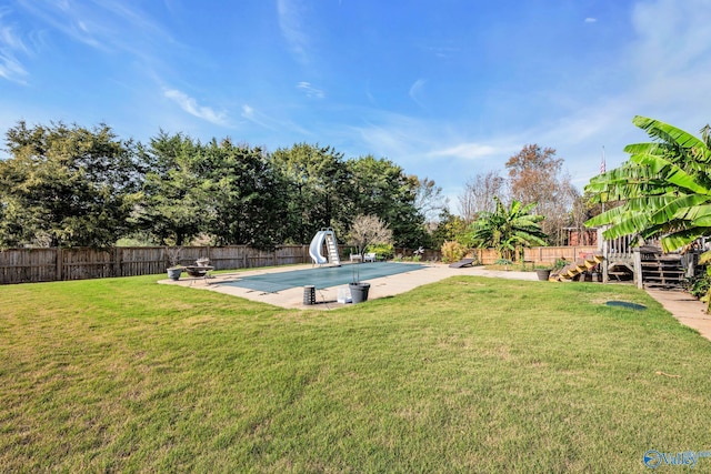 view of yard with a covered pool