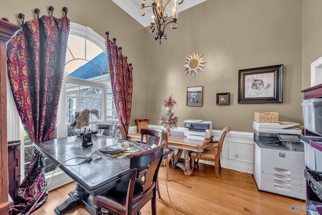 102 Casey Dr, Huntsville, AL 35806 - dining room with a chandelier, healthy amount of natural light, wood finished floors, a wainscoted wall, and a towering ceiling