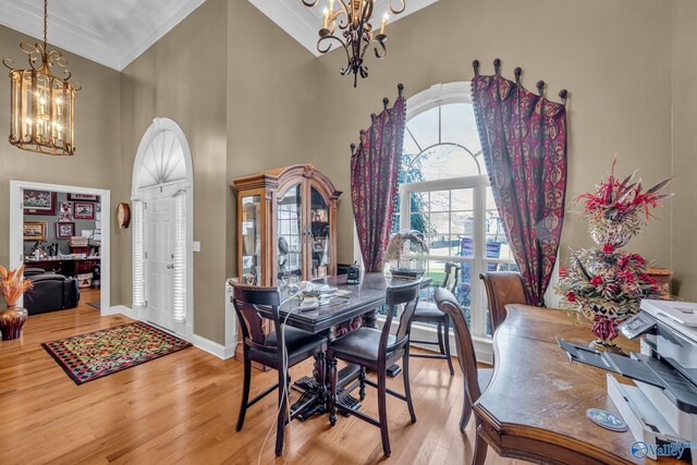 102 Casey Dr, Huntsville, AL 35806 - dining space featuring a chandelier, crown molding, wood finished floors, and a high ceiling