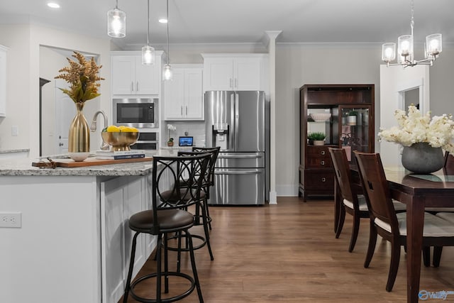 kitchen with tasteful backsplash, white cabinets, stainless steel fridge with ice dispenser, dark wood-type flooring, and built in microwave