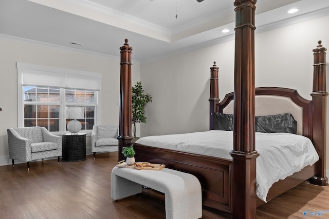 bedroom with crown molding, visible vents, wood finished floors, and recessed lighting