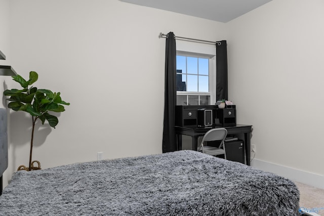 carpeted bedroom with baseboards