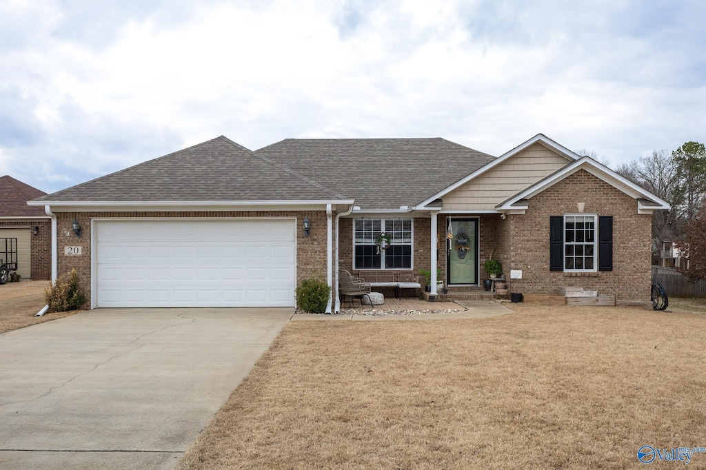 view of front of home featuring a garage and a front lawn