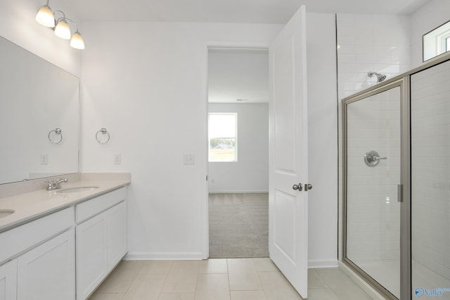 bathroom with tile patterned flooring, vanity, and an enclosed shower