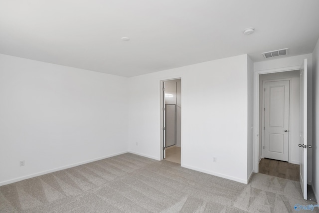 spare room with light colored carpet