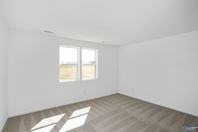 unfurnished room with light colored carpet