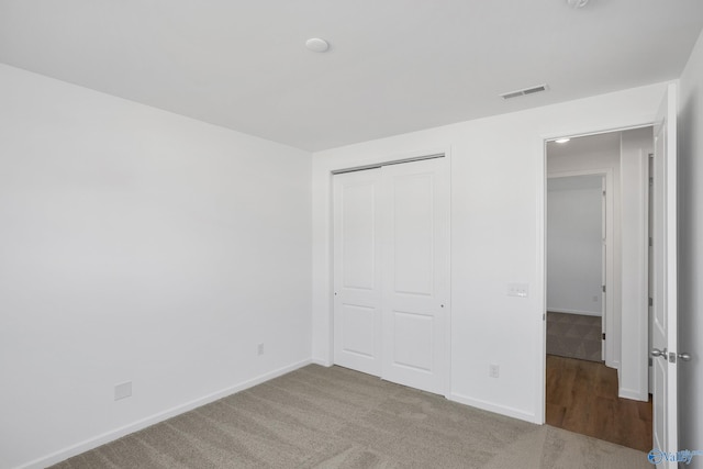 unfurnished bedroom with a closet and carpet