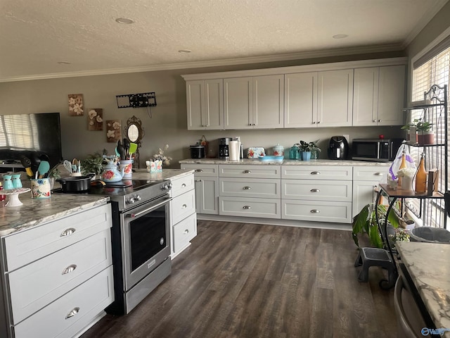 kitchen with light stone countertops, appliances with stainless steel finishes, dark wood-type flooring, and ornamental molding