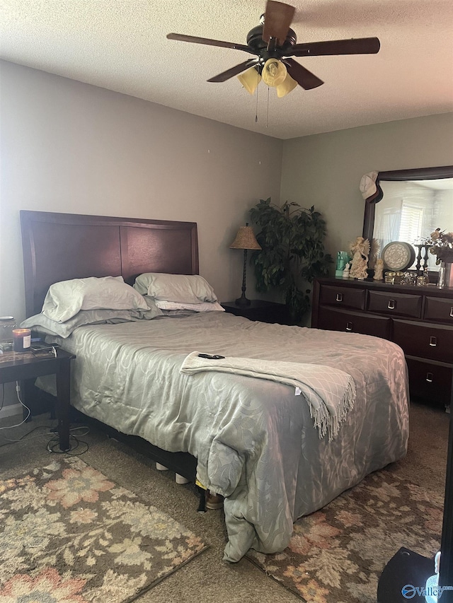 carpeted bedroom with a textured ceiling and ceiling fan