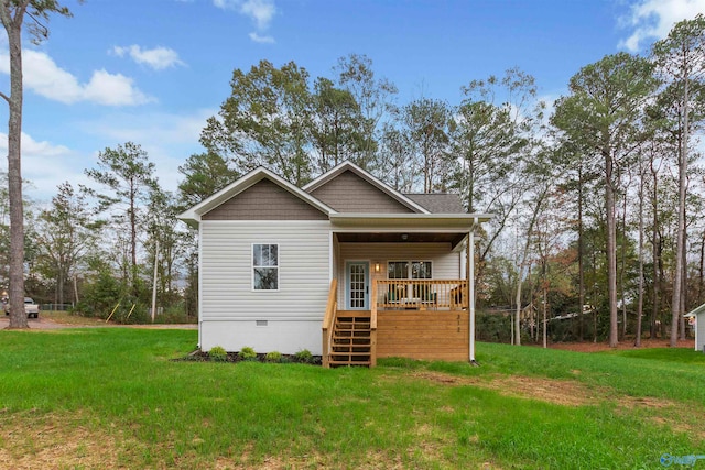 rear view of property featuring a lawn