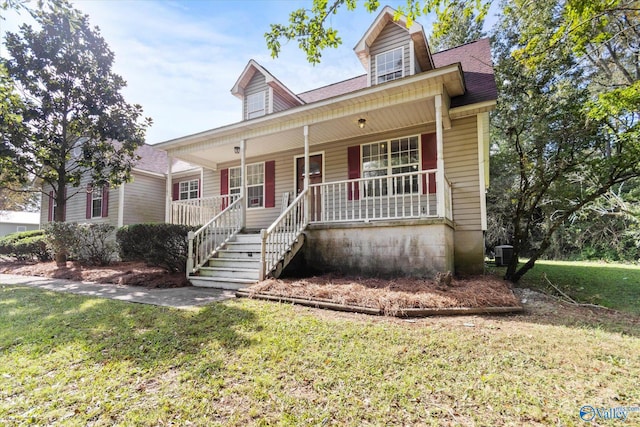 new england style home featuring a front lawn, covered porch, and central AC unit