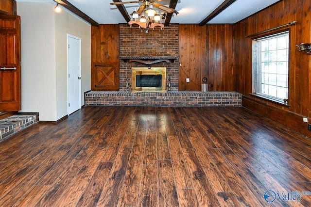 148 Maple Blvd, Gurley, AL 35748 - unfurnished living room with beamed ceiling, dark hardwood / wood-style floors, a brick fireplace, and wood walls