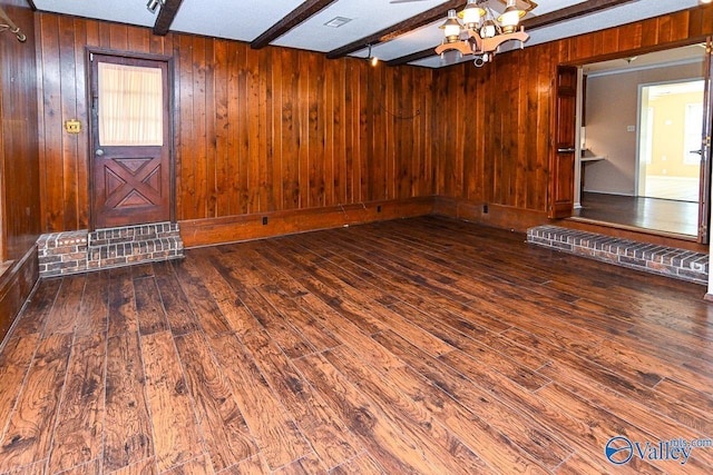 148 Maple Blvd, Gurley, AL 35748 - unfurnished living room featuring wood-type flooring, wooden walls, and beam ceiling