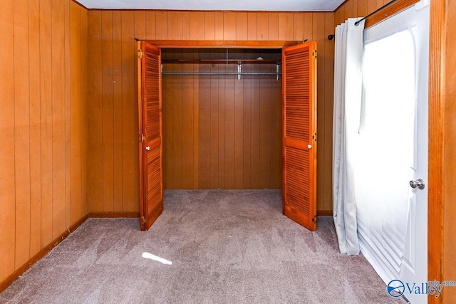148 Maple Blvd, Gurley, AL 35748 - unfurnished bedroom with light colored carpet, wooden walls, and a closet