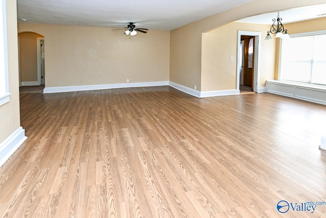 148 Maple Blvd, Gurley, AL 35748 - empty room with ceiling fan with notable chandelier and light wood-type flooring