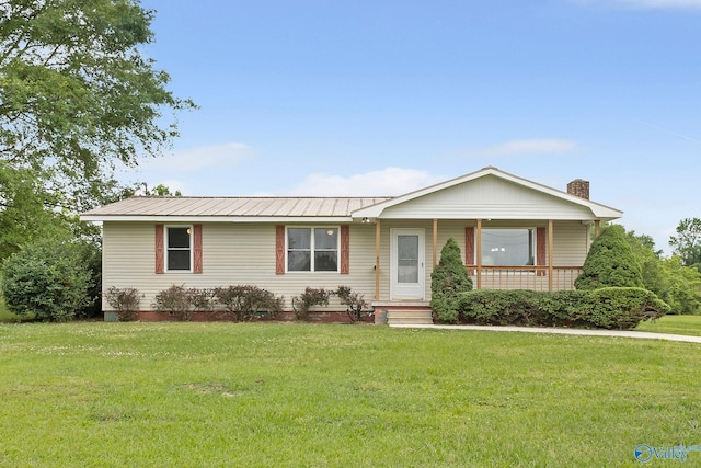 431 County Road 449, Town Creek, AL 35672 - ranch-style home featuring covered porch, a front yard, a chimney, and metal roof