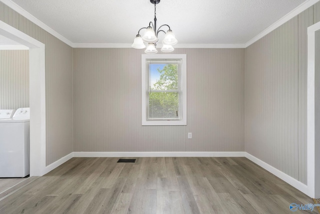 431 County Road 449, Town Creek, AL 35672 - empty room with separate washer and dryer, light wood finished floors, ornamental molding, a chandelier, and baseboards