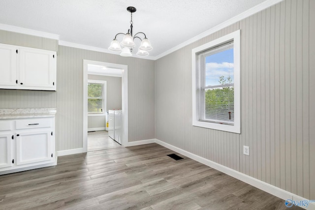 431 County Road 449, Town Creek, AL 35672 - unfurnished dining area with ornamental molding, washer and clothes dryer, a chandelier, baseboards, and light wood-style floors