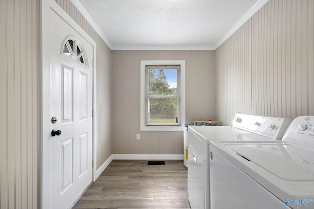 431 County Road 449, Town Creek, AL 35672 - laundry room featuring crown molding, baseboards, washer and clothes dryer, wood finished floors, and a textured ceiling