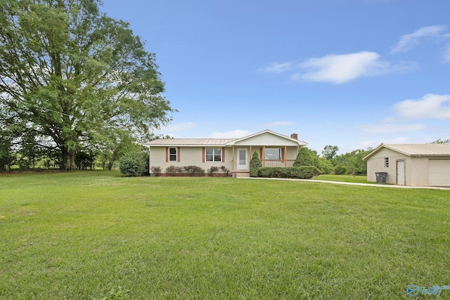 431 County Road 449, Town Creek, AL 35672 - ranch-style house with a front yard, a garage, metal roof, and a chimney
