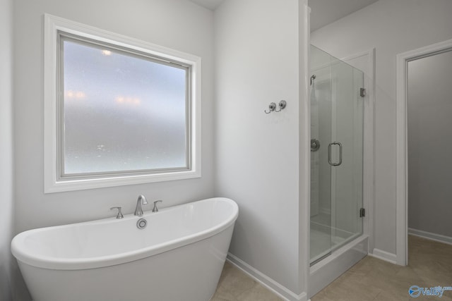 1603 Calistoga Cir, Huntsville, AL 35811 - full bath featuring a stall shower, a freestanding tub, baseboards, and tile patterned flooring