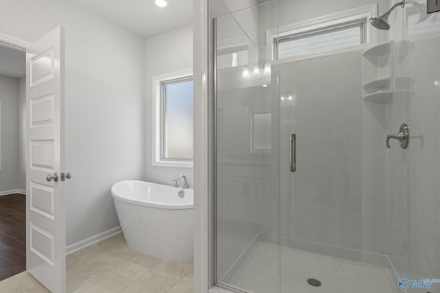 1603 Calistoga Cir, Huntsville, AL 35811 - full bath featuring a stall shower, a freestanding bath, and baseboards