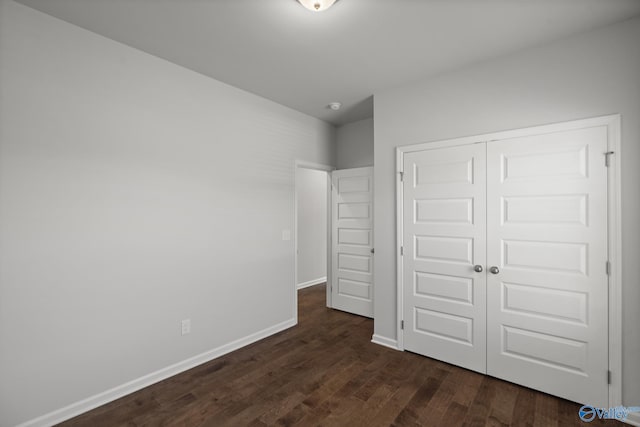 1603 Calistoga Cir, Huntsville, AL 35811 - unfurnished bedroom featuring dark wood-type flooring, a closet, and baseboards