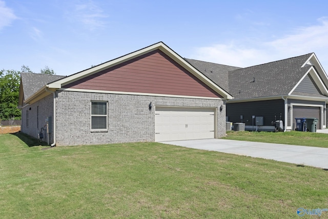 1603 Calistoga Cir, Huntsville, AL 35811 - view of side of property with cooling unit, brick siding, a yard, and a garage