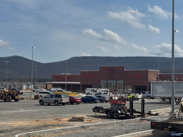 uncovered parking lot featuring a mountain view