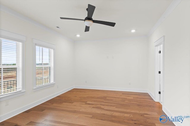 spare room featuring light wood-style flooring, recessed lighting, visible vents, baseboards, and crown molding