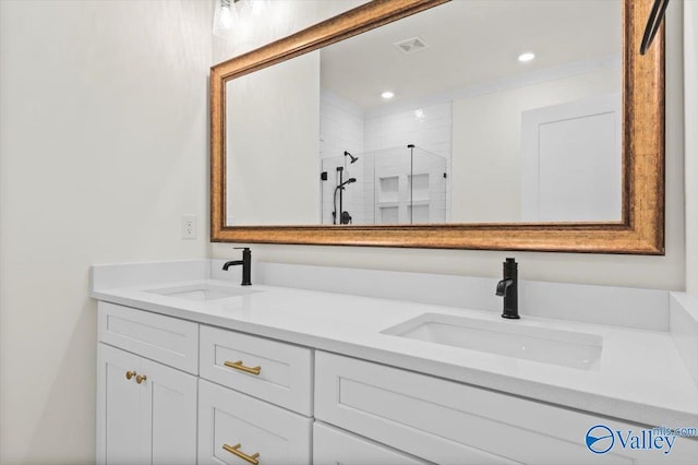 bathroom with visible vents, a sink, a shower stall, and double vanity