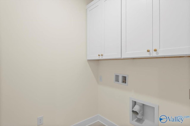 clothes washing area featuring washer hookup, cabinet space, and baseboards