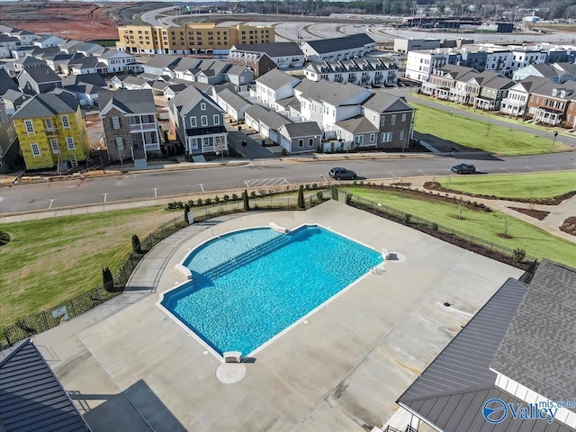 view of swimming pool featuring a residential view and fence