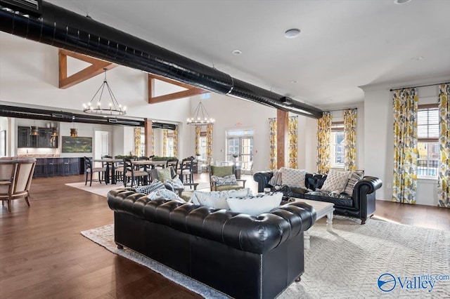 living area with a chandelier and wood finished floors