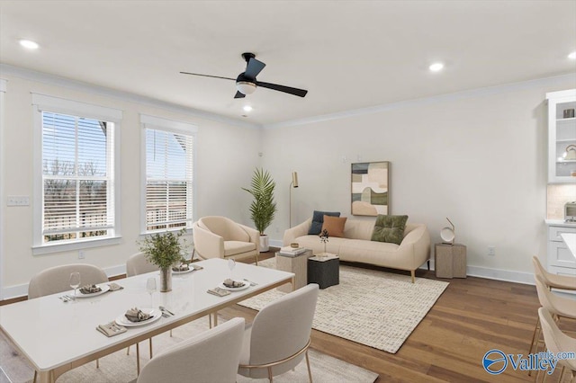 living area with crown molding, recessed lighting, dark wood-type flooring, ceiling fan, and baseboards