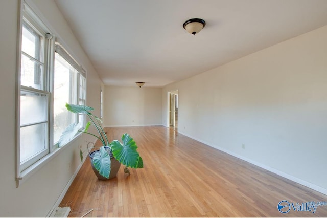 unfurnished room featuring a healthy amount of sunlight and light hardwood / wood-style flooring