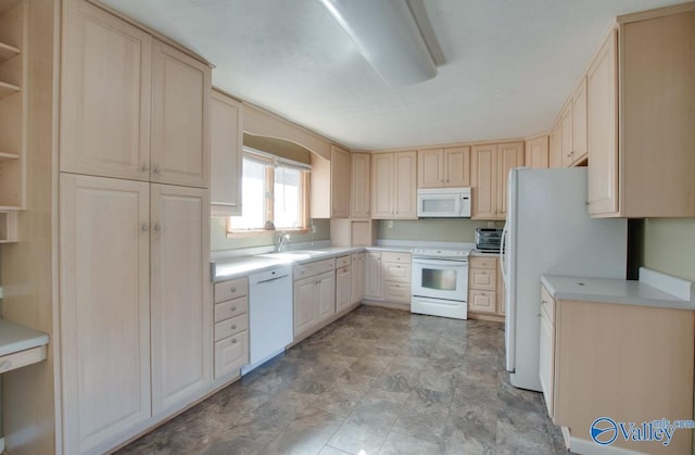 kitchen featuring sink, white appliances, and light brown cabinets